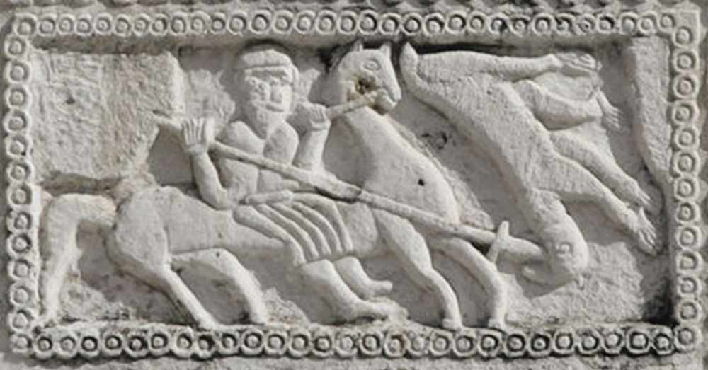 In a bas-relief stone carving, Perun reaches forth from his chariot to spear Veles, represented as a stylized bear.